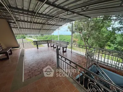 Spacious covered balcony with scenic view and seating area