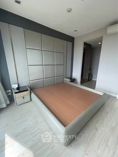 Spacious modern bedroom with sleek design and ample natural light