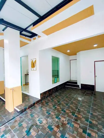 Modern interior with stylish ceiling and tiled flooring, showcasing contemporary design elements.