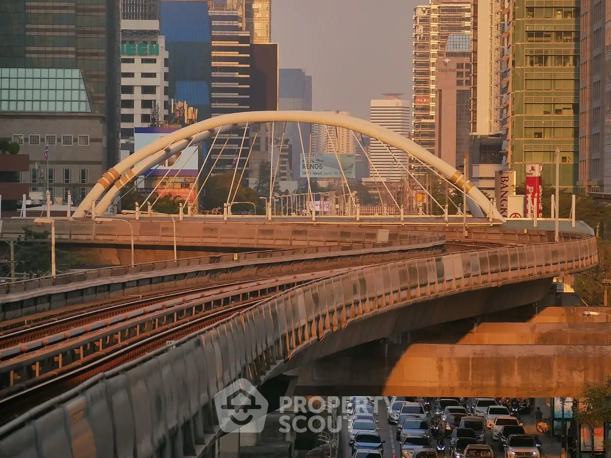 Stunning urban cityscape with modern bridge and high-rise buildings at sunset.