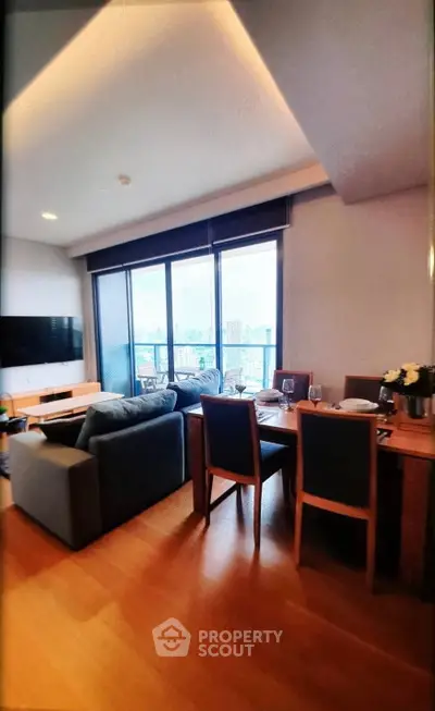 Spacious living room with modern furniture and city view, perfect for urban living.