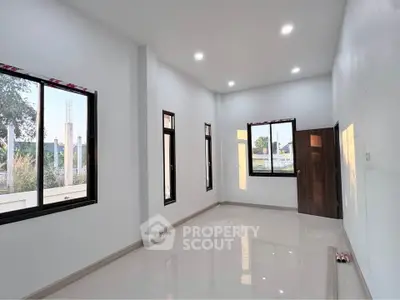 Spacious modern room with large windows and glossy floor