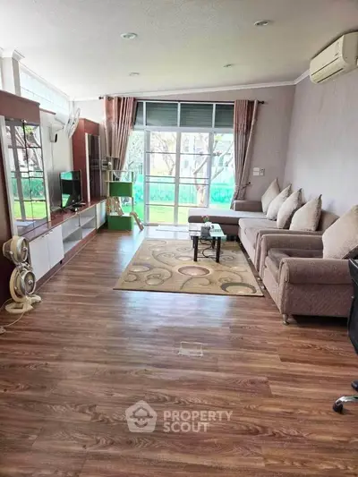 Spacious living room with modern decor and large windows for natural light.