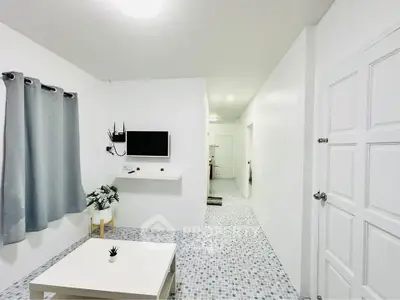 Modern minimalist living room with white decor and tiled flooring