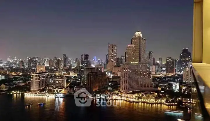 Stunning city skyline view from a high-rise balcony at night, showcasing vibrant urban lights.