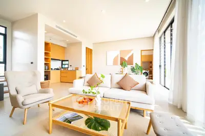 Spacious modern living room with open kitchen and natural light