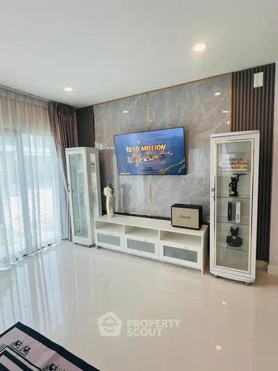 Modern living room with sleek TV setup and elegant display cabinets