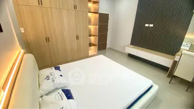 Modern bedroom with stylish wooden wardrobe and cozy lighting