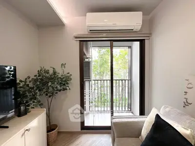 Modern living room with balcony view and air conditioning, featuring cozy sofa and stylish decor.