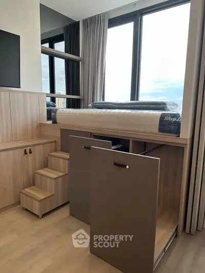 Modern bedroom with elevated bed and storage steps, featuring large windows and sleek wooden design.