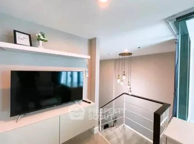 Modern interior with sleek TV setup and stylish lighting in a contemporary home.