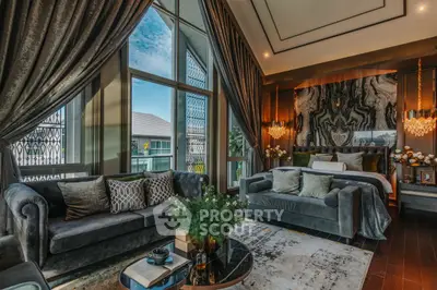 Luxurious bedroom with elegant decor and large windows offering stunning views.