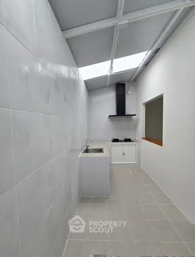 Modern minimalist kitchen with skylight and sleek tile design