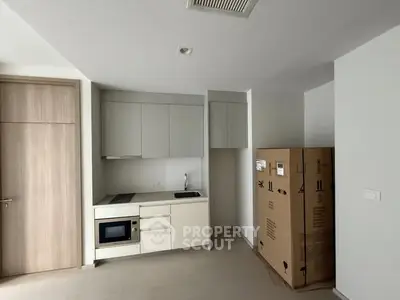 Modern compact kitchen with built-in appliances and minimalist design
