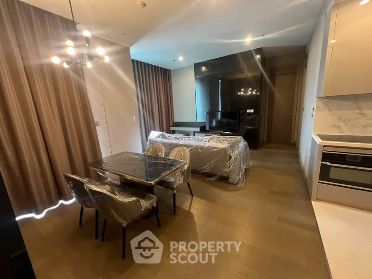 Modern living room with elegant dining area and stylish lighting, featuring a cozy ambiance and contemporary design.