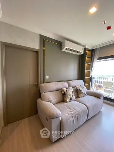 Modern living room with cozy sofa and balcony view in stylish apartment.
