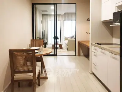 Modern open-plan kitchen and dining area with stylish furniture and natural light.