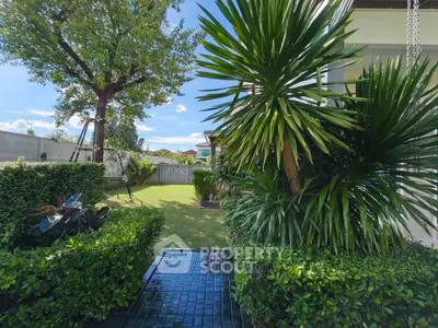 Lush garden view with vibrant greenery and modern exterior, perfect for serene outdoor living.