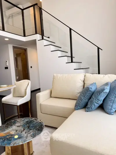 Modern duplex living room with elegant staircase and stylish furniture