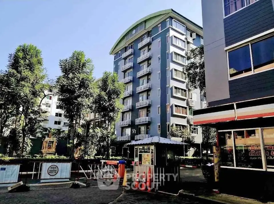 Modern apartment building with lush greenery and secure entrance