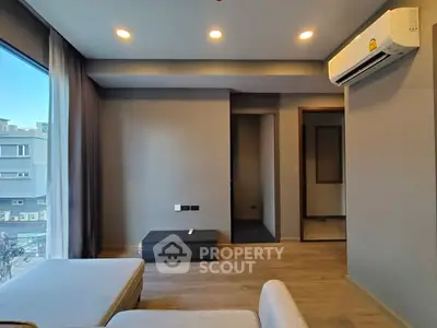 Modern living room with large window and air conditioning unit