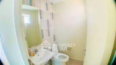Compact bathroom with modern fixtures and stylish tile accents.