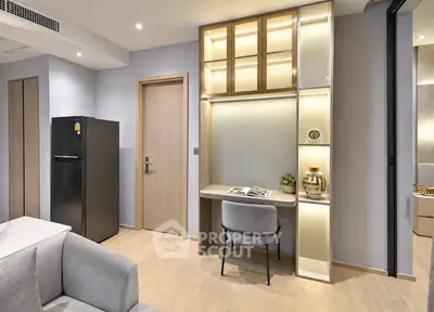 Modern apartment interior with stylish study area and sleek refrigerator