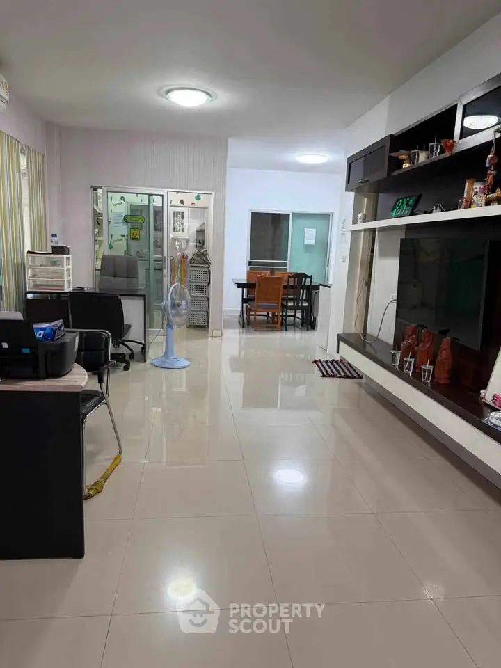 Spacious living room with modern decor and ample natural light, perfect for family gatherings.