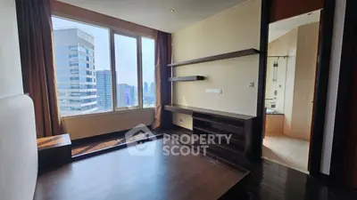 Spacious bedroom with city view and modern shelving