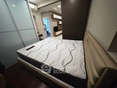 Modern bedroom with stylish bed and sleek design, featuring built-in storage and contemporary decor.