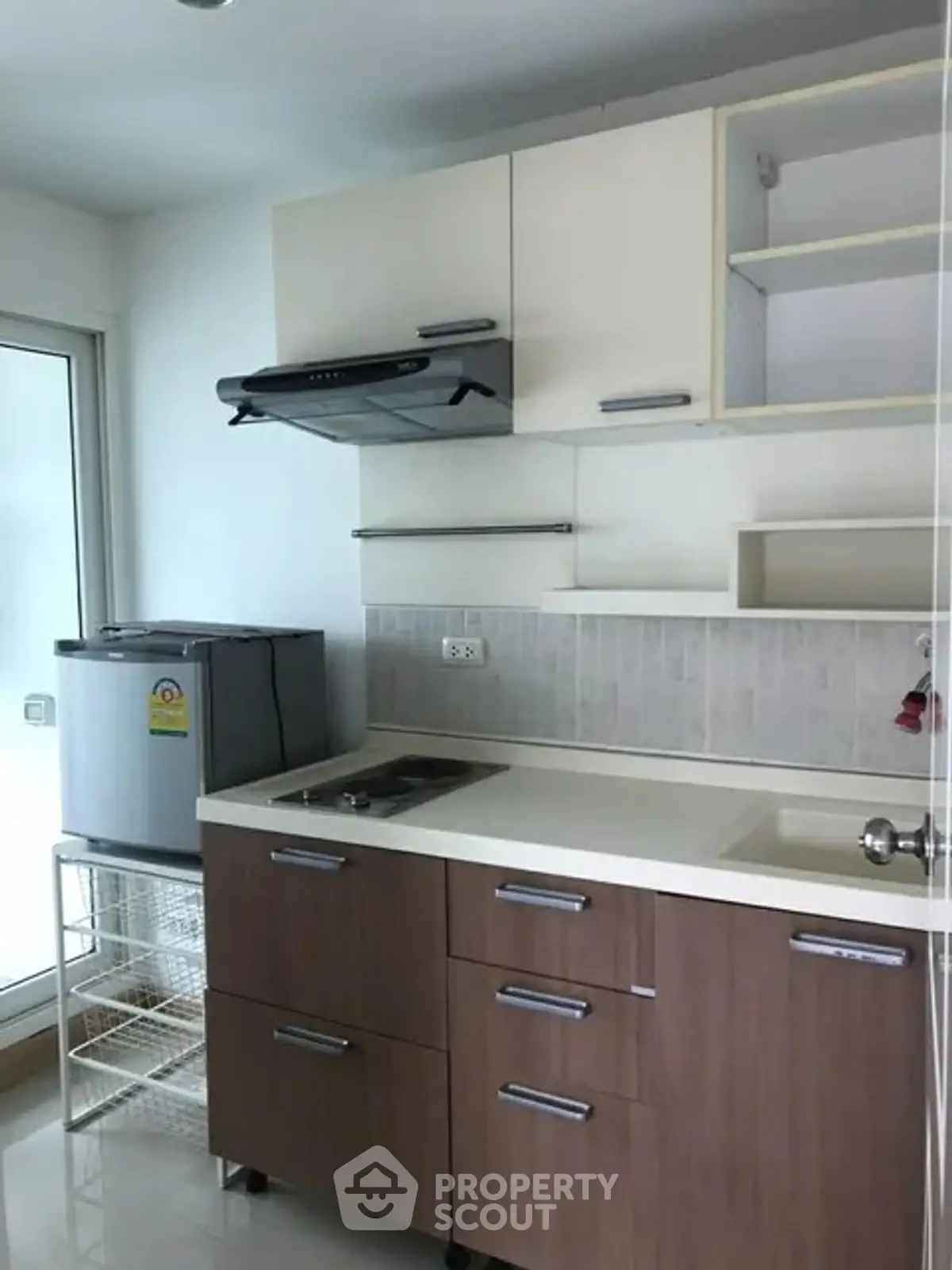 Modern kitchen with sleek cabinetry and compact appliances in a bright, minimalist design.