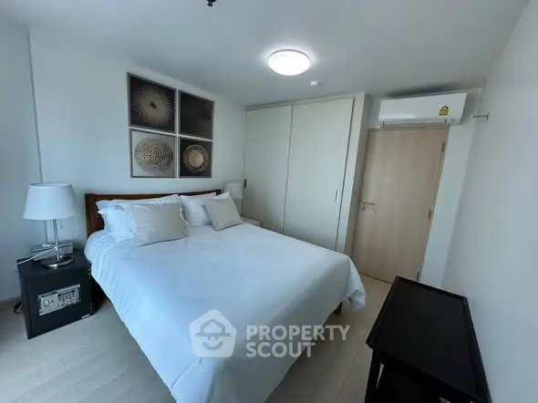 Modern bedroom with stylish decor and ample natural light