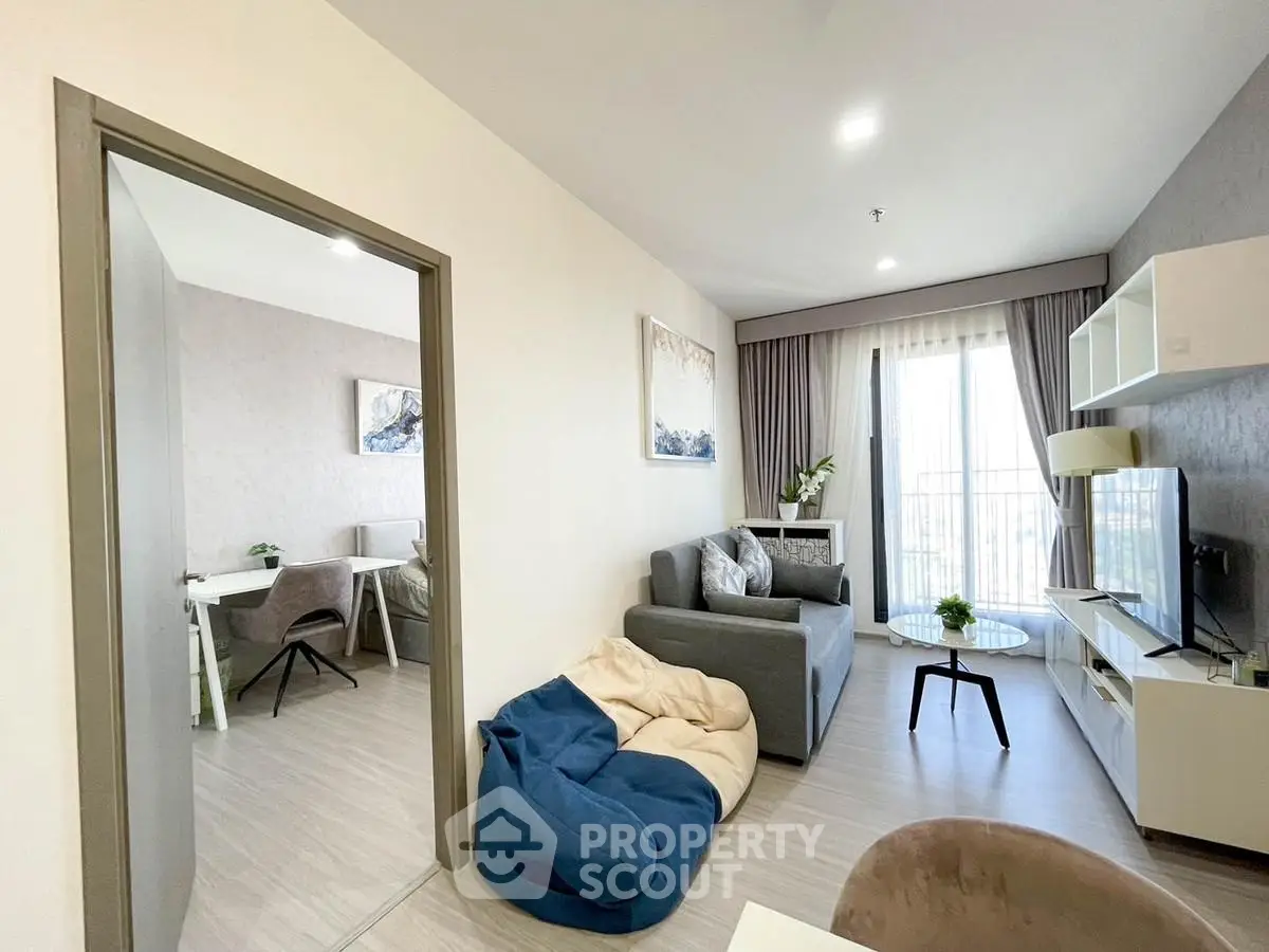 Modern living room with cozy seating and natural light, perfect for relaxation and entertainment.