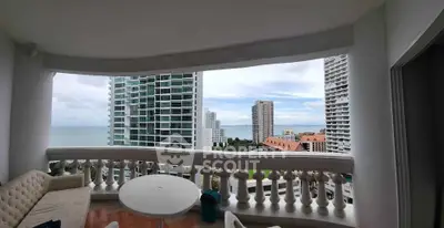 Stunning balcony view with ocean and cityscape, perfect for relaxation and enjoying the scenery.