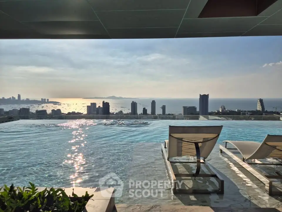 Luxurious rooftop infinity pool with stunning city and ocean views at sunset.