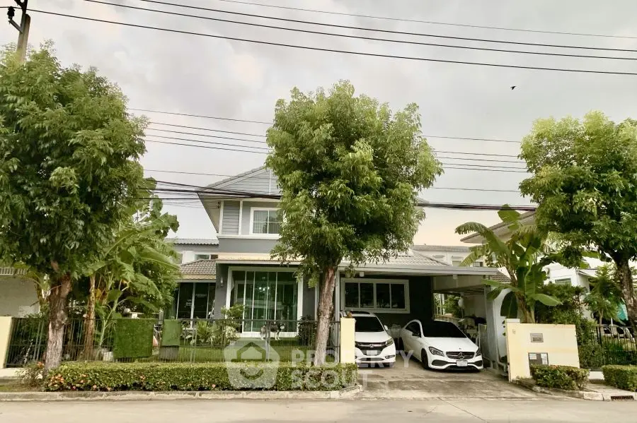 Charming suburban house with lush garden and two-car garage in tranquil neighborhood.