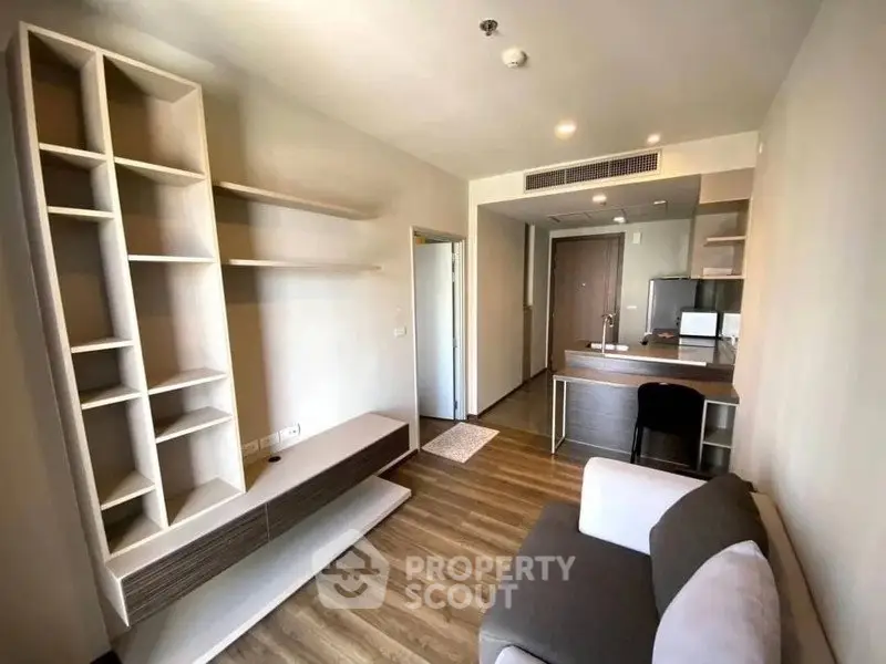 Modern living room with sleek shelving and cozy sofa in stylish apartment