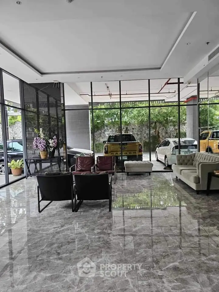 Modern building entrance with sleek marble flooring and stylish seating area