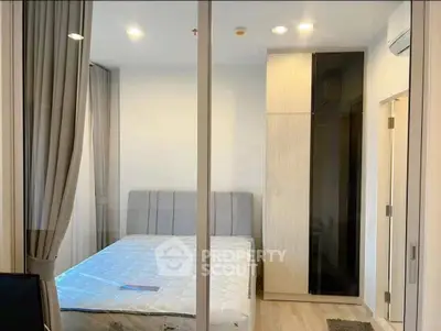 Modern bedroom with sleek design and ample natural light, featuring a comfortable bed and stylish wardrobe.
