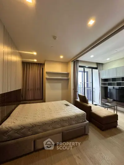 Spacious modern bedroom with balcony access and stylish furnishings