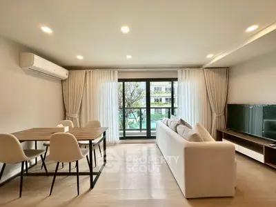 Spacious modern living room with large windows and elegant decor