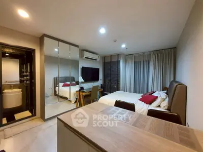 Modern bedroom with stylish decor and mirrored closet doors