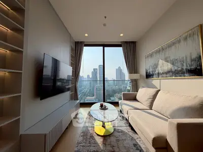 Modern living room with city view, stylish sofa, and wall-mounted TV