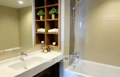 Modern bathroom with sleek fixtures and built-in shelving for a luxurious feel.