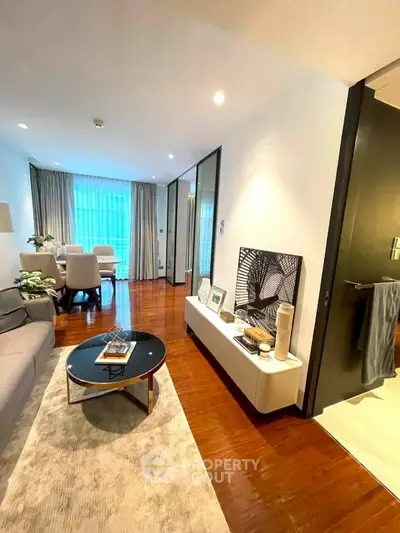 Stylish living room with modern decor and hardwood floors in a contemporary apartment.