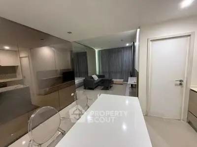 Modern open-plan living room with sleek furniture and glossy finishes