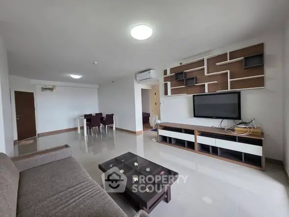 Spacious modern living room with stylish TV unit and dining area