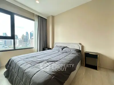 Modern bedroom with city view, featuring a cozy bed and stylish decor, perfect for urban living.