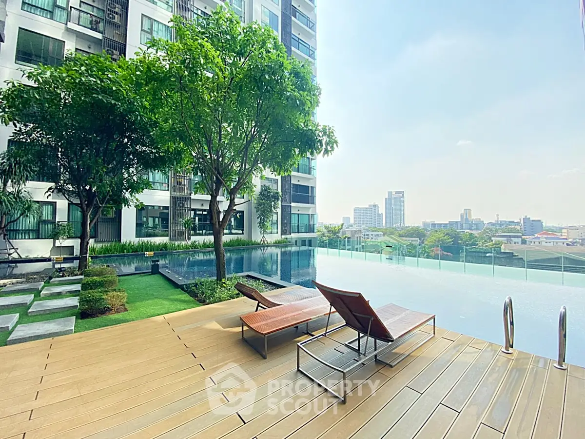 Luxurious apartment pool area with stunning city views and modern lounge chairs.