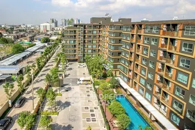 Modern apartment complex with pool and parking in urban setting